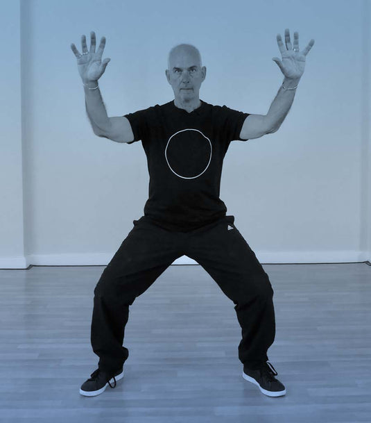 Why do we keep the upper back wide in qigong?